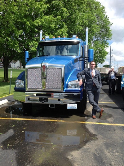 Kurt Swihart, marketing director of Kenworth Truck Company, poses with the new T880 40-inch sleeper.