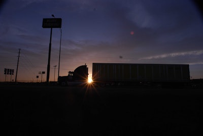 Semi truck parked in a truck stop parking lot