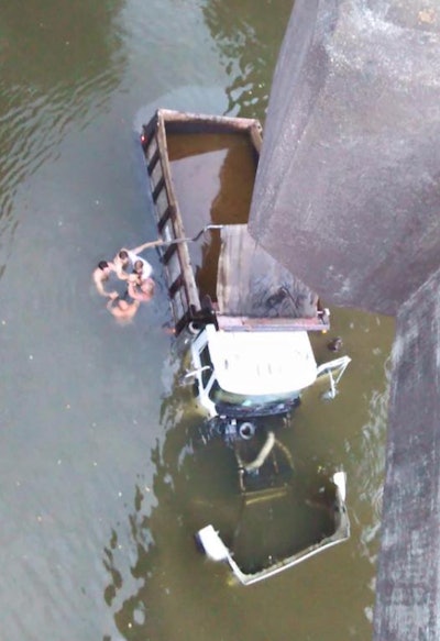 A deadly collision involving two dump trucks sent both trucks plummeting from a bridge near Covington, Ga. into the Yellow River. A group of men shown above were not able to rescue one of the drivers who was underwater, pinned under his truck. (Photo Tweeted by CBS46)