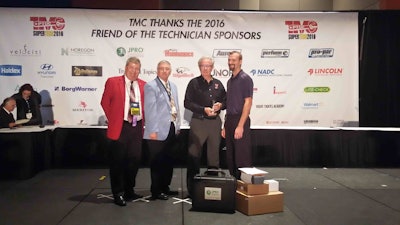 Vos, far right, is congratulated by TMC SuperTech Chairman George Arrants. Joining them was TMC Chairman Doug White, far left, and Winston Minchew, Chairman of PTDC and training manager for Old Dominion.
