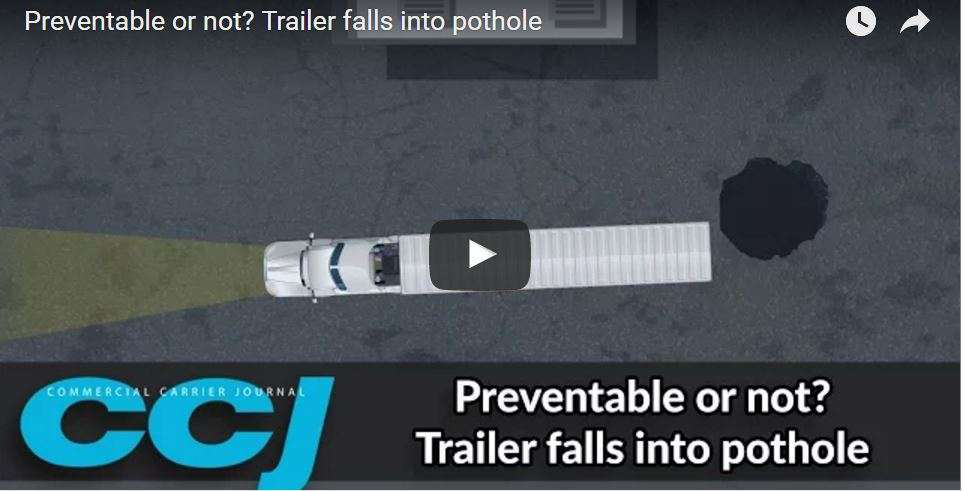 trailer falls into pothole