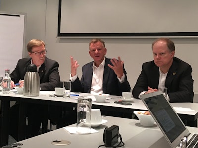 Troy Clarke, left, and Andreas Renschler, middle, talked the fledgling partnership between Navistar and Volkswagen at a meeting with trucking industry press at the bi-annual IAA show in Hanover, Germany, Sept. 21.