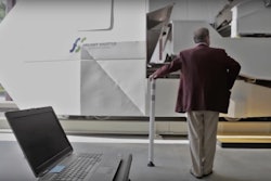 Texas A&M University Chancellor John Sharp stands in front of the university’s Freight Shuttle System prototype.