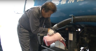 A Toho employee in Osaka, Japan pours a fragrant oil into a sewage truck which emits a chocolate scent.