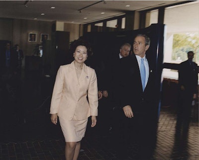 Elaine Chao, left, walks with former President George W. Bush during her time as Secretary of Labor, a post she held from 2001-2009. (Photo courtesy of Chao’s Flickr account.)