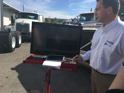 Greg O’Connor, Nextran Truck Center’s director of service operations, demonstrates how the company’s diagnostics platform reads fault data from the truck.