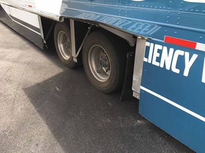 A composite skirt runs the length of the trailer and features liftable panels that allow for tire access.