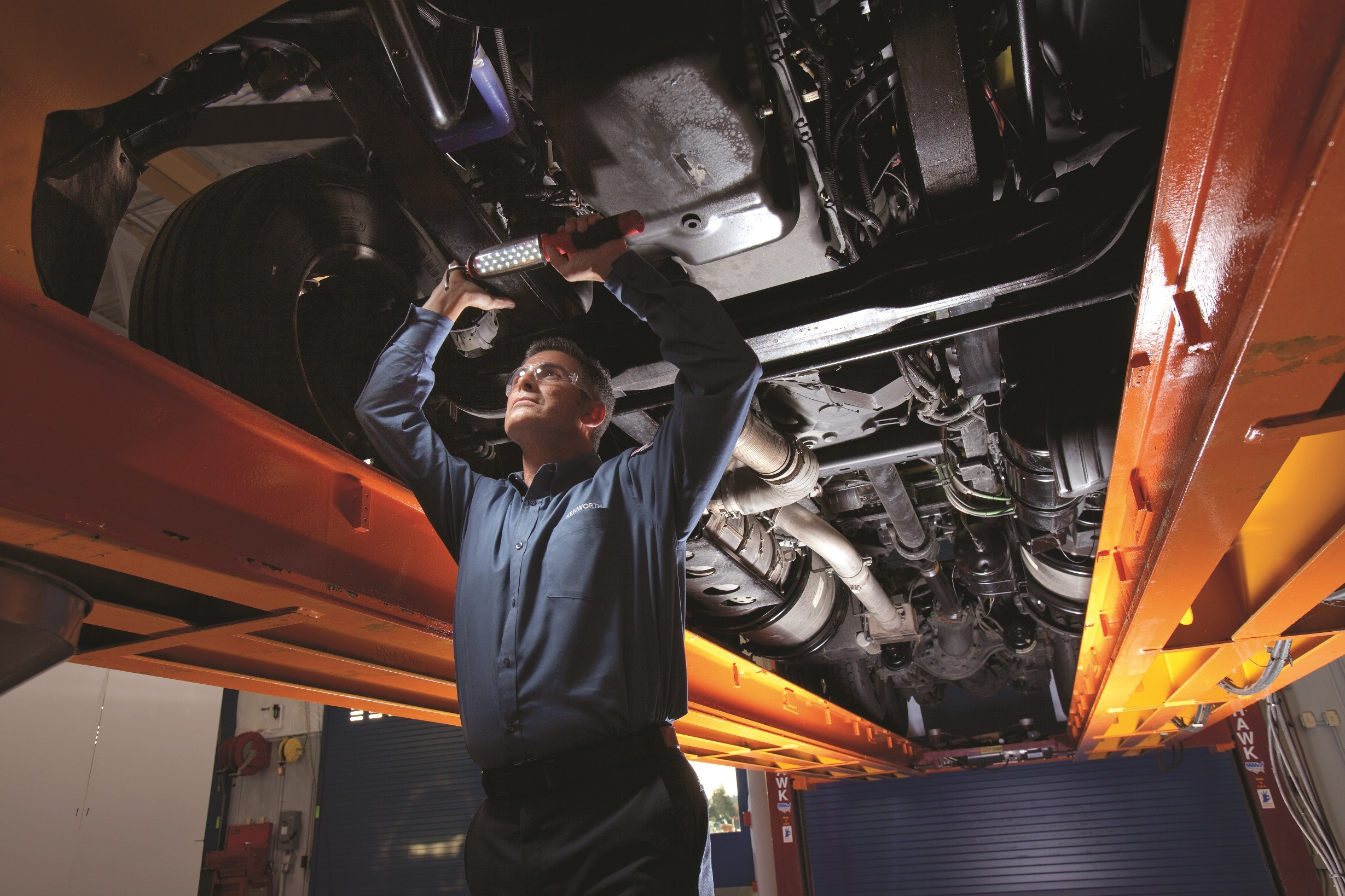 Mechanic checking under a semi truck