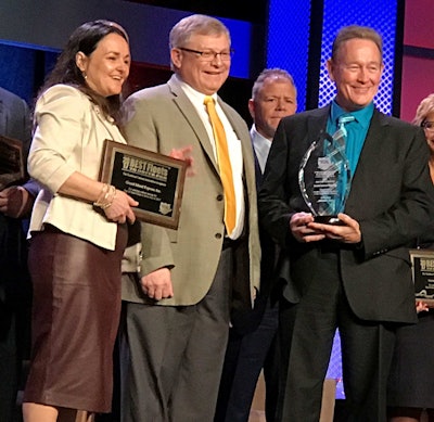 Tom Pirnie (right), Grand Island Express, accepts the Best Fleets to Drive For award in the small fleet category.