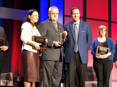 Bison Transport’s Garth Pitzel, second from left, accepts the Best Fleets to Drive For award earlier this year.