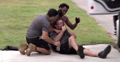 A truck driver is aided by his co-workers after being shot during a recent road rage incident in Miami. (Photo from Facebook page of cbsmiami.com.)
