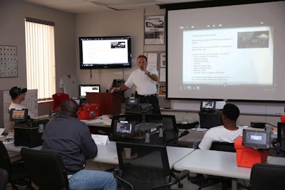 An instructor trains new drivers attending orientation meetings at Arnold Transportation on the dangers of distracted driving