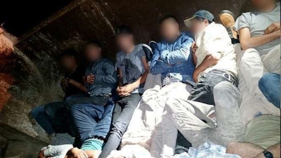 Illegal immigrants shown here in the back of a dump truck were recently arrested for trying to unlawfully enter the U.S. from Mexico. (Photo: U.S. Customs and Border Protection.)