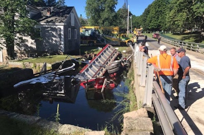 A 73-year-old asphalt truck driver was rescued Thursday morning after crashing into a Massachusetts pond. (Photo: Rochester, Mass. Fire Department).