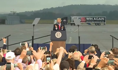 A tractor-trailer touting Trump’s tax reform message was staged behind him during the 45-minute speech. The trailer reads “Win Again — Lower taxes. Bigger paychecks. More jobs.”