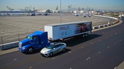 Toyota’s Project Portal hydrogen fuel cell semi next to the Toyota Mirai sedan, which is also powered by hydrogen.