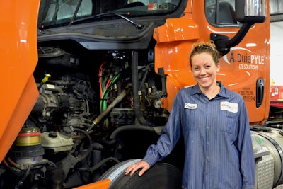 Female Working Under the Hood of a Semi-Truck