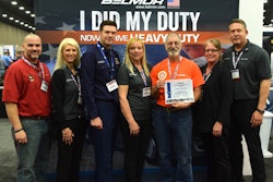 Larry Berman was honored at MATS in Belmor’s “I Did My Duty…Now I Drive Heavy Duty” contest. Pictured from left to right are: Paul Thompson, military recruiting manager, U.S. Express; Valerie Nadalini, senior director of brand engagement, Lund International; AET2 Blair Petterson, recruiter, Coast Guard; Mary Berman; Larry Berman; Kelli Brooks, director of customer development, Lund International; and Ralph Banks, vice president of sales, heavy trucking, Lund International.