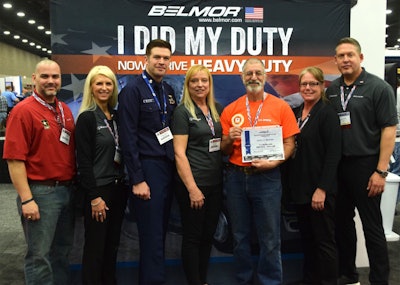Larry Berman was honored at MATS in Belmor’s “I Did My Duty…Now I Drive Heavy Duty” contest. Pictured from left to right are: Paul Thompson, military recruiting manager, U.S. Express; Valerie Nadalini, senior director of brand engagement, Lund International; AET2 Blair Petterson, recruiter, Coast Guard; Mary Berman; Larry Berman; Kelli Brooks, director of customer development, Lund International; and Ralph Banks, vice president of sales, heavy trucking, Lund International.
