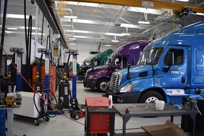 Multiple Prime Inc. trucks parked in a service bay