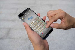 Man’s hand using mobile smartphone with green screen