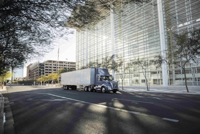 Volvo semi truck tractor riding in a city
