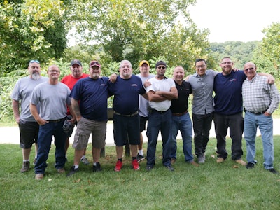 Evan Pohaski, 4th from right, has assembled a staff and designed new processes and technology that center on giving drivers a marquee work experience.