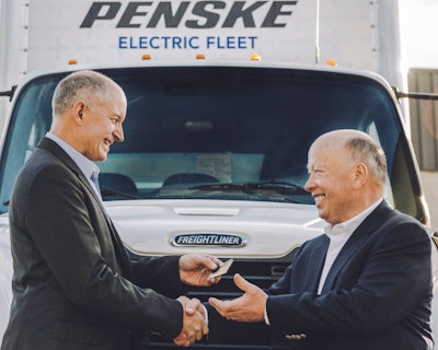 Daimler Trucks North America President and CEO Roger Nielsen handing eM2 key to Penske Truck Leasing President and CEO Brian Hard