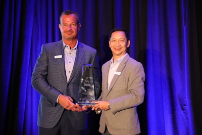 Load One’s John Elliott, CEO, and Edgardo de Leon, CIO, accept the CCJ Innovator of the Year award.