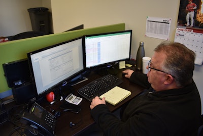 A sales manager for ShipEX Logistics reviews lane pricing data from DAT and Truckstop.com