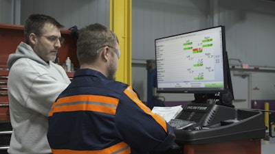 Truck mechanics looking at truck diagnostics