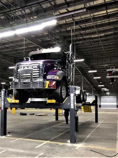 Mack semi truck on lifts for service