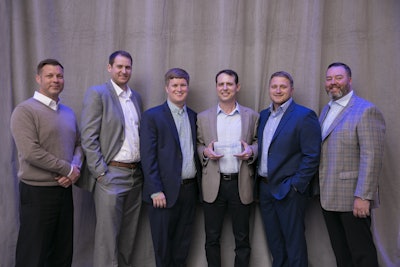 Ben Hartman holds the award that Cheetah Transportation, an expedite flatbed carrier based in Houston, received as the Carrier of the Year in the Flatbed category.