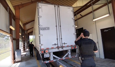 Inspectors checking a semi-truck
