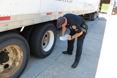 cvsa inspector checking semi truck