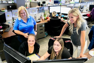 Kimberly Cage, top left, director of training for C.R. England works with Pam Wilson to establish new call center processes. (Image courtesy of C.R. England)