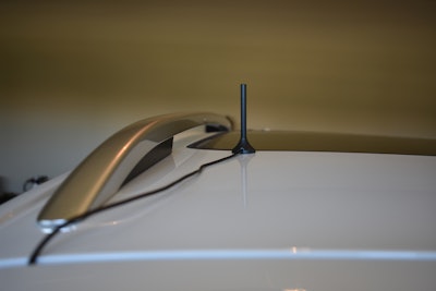 An outside antenna mounts to the roof and routes through any door opening.
