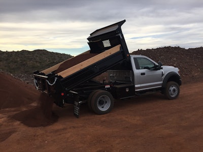 2020 Ford F-450 dump truck releasing a load of dirt