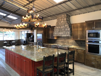 Tri-State’s Legacy Lodge features a custom kitchen, fitness center, theatre rooms, laundry center, hand-hewn beam chandeliers, polished metal ceilings, men and women locker rooms and a club room anchored with a 20-foot-high stone fireplace.