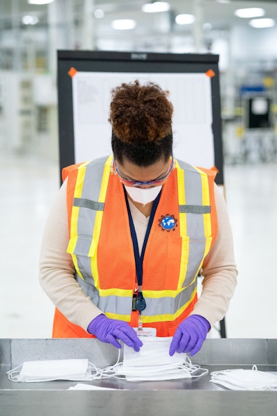 Engineers and technicians set-up and test the machines that will be used to manufacture Level 1 face masks Monday, March 30, 2020 at the General Motors Warren, Michigan manufacturing facility. Production will begin next week and within two weeks ramp up to 50,000 masks per day, with the potential to increase to 100,000 per day. (Photo by John F. Martin for General Motors)