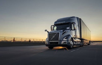 volvo semi truck on the road at sunset