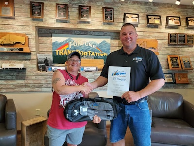 Leland Krumrey, driver services manager at Fortune Transportation, presents an award to a driver for 500,000 safe miles.