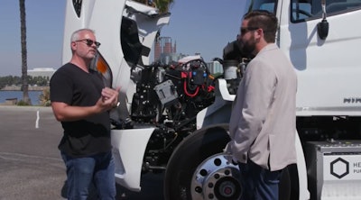 Glen Ellis, Hino senior vice president of customer experience and Eric Coupal-Sikes, Hexagon Purus vice president of e-mobility, discuss the capabilities of a battery electric Class 7 Hino tractor with Hexagon Purus’ full electric dual motor drive e-axle system.