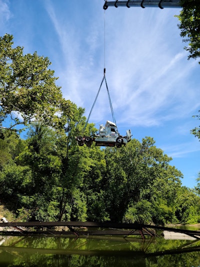 A crane removed the 2020 Freightliner Cascadia the next day following the Pentecostal bridge collapse in Westphalia, Missouri.