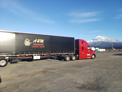 AM Transport semi truck with mountain in background