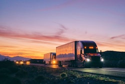 semi trucks on the highway at dusk