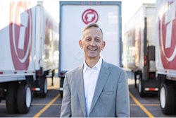 Keith Wilson, president of Titan Freight Systems, standing in front of Titan Freight semi-trucks