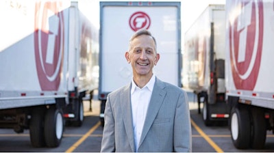 Keith Wilson, president of Titan Freight Systems, standing in front of Titan Freight semi-trucks
