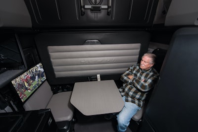 Liquid Trucking driver sitting at table watching football on TV