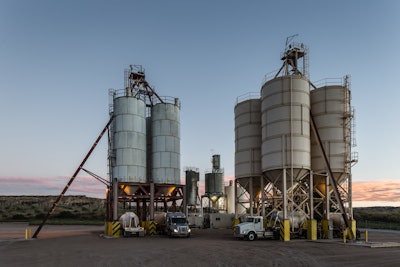 Silos loading hopper trucks in New Mexico